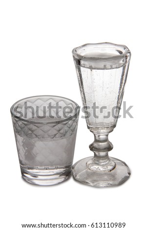 Vodka in a glass and decanter on a white background