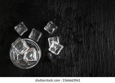 Vodka Glass With Ice On Black Table. Copy Space