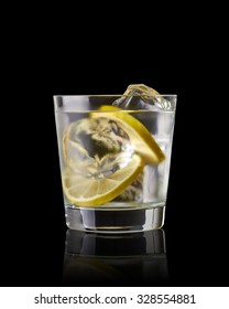 Vodka Lime, Gimlet Or Gin Tonic With Ice In Glass On Black Background 