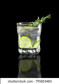 Vodka, Lime Wedge With Ice In Rocks Glass On Black Background With Reflection