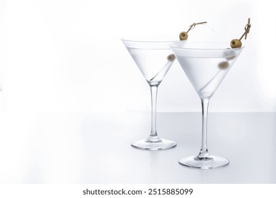 Vodka martini cocktail with vodka and vermouth and green olives on white background. Copy space - Powered by Shutterstock