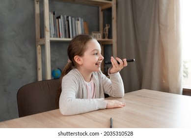 Voice Assistant. Happy Girl Dictates Text Using Microphone Of Smartphone Or Mobile Phone. Student On The Phone Records An Audio Message. Voice Sms Recording.copy Space