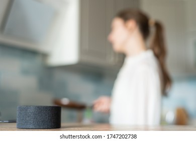 The Voice Assistant In The Kitchen Plays Music, Cheerful Girl Dances In The Background