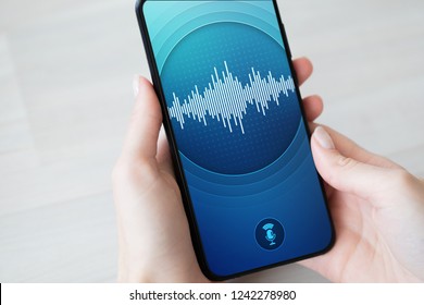 Voice recognition application on smartphone screen. Artificial intelligence and deep learning concept.