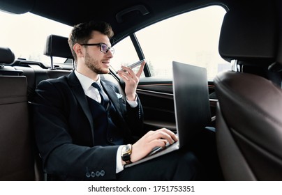 Voice Recognition, Search Technology Concept. Worker In Glasses Using Smart Phone And Pc Sitting In Car