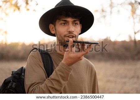 Voice recognition, search technology concept. Arabic man tourist talking on her mobile phone. Copy space