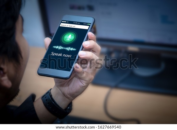 Voice recognition,search\
technology concept.Close-up of businessman talking on his mobile\
phone