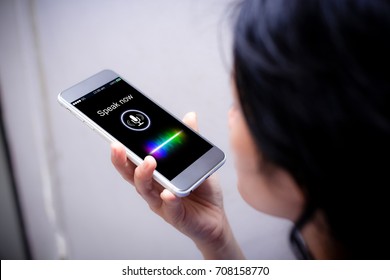 Voice recognition,search technology concept.Close-up of woman talking on her mobile phone - Shutterstock ID 708158770