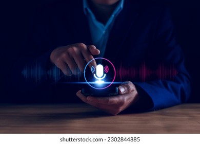 Voice recording. Man touching microphone icon on smart phone. Mobile application Record sound, audio, music, voice message. or Use your voice to direct AI to search for information on Internet.