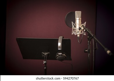 Voice recording studio set up, with microphone, music stand and headphones, horizontal - Powered by Shutterstock