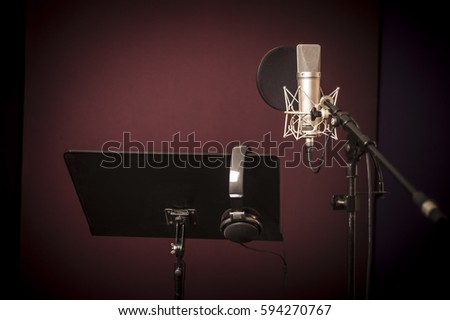 Voice recording studio set up, with microphone, music stand and headphones, horizontal