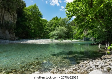 Voidomatis river bank and trees in Epirus, Greece on a summer day - Shutterstock ID 2070682085