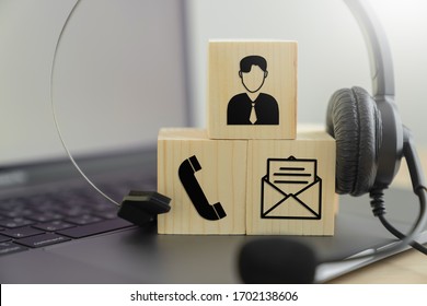 VOIP Headset And Icon Communication On The Wood Block. Concept Call Center Support.