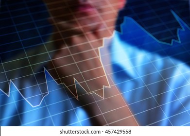 Volatile Abstract Graph. Stock Market Graph At Background A Thinking Trader. The Graph Illustrates Market Volatility, Turbulence, Instability. 