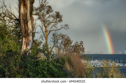 Volatile Spring Weather Creates A Rainbow Over The Puget Sound In Seattle, Washington