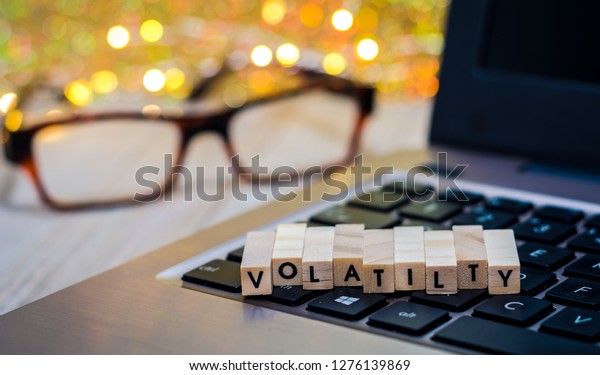 Volatility still life business finance concept with laptop, stock chart, shallow DOF