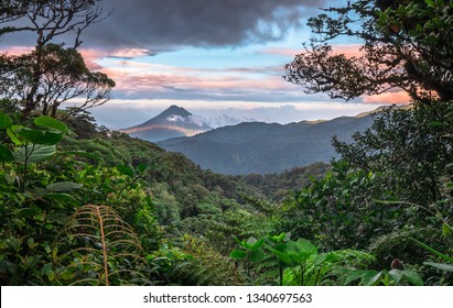 Volcan Arenal dominates the landscape during sunset, as seen from the Monteverde area, Costa Rica.