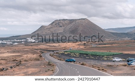Volcan de la Corona, Lanzarote, street with cars, canary islands, Spain
