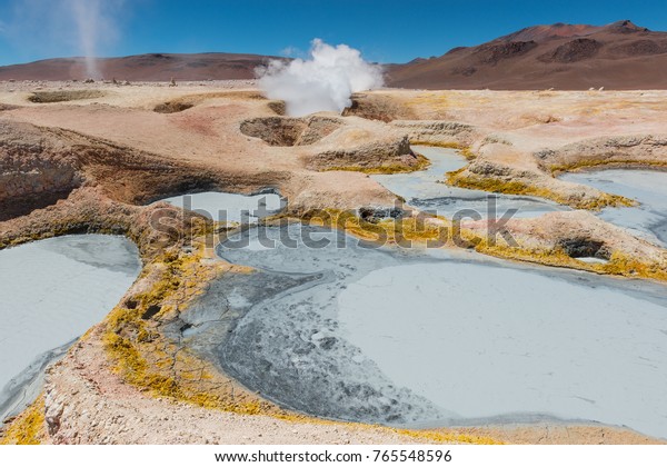 Volcanic activity with fumaroles and mud pits at\
Sol de Mañana, together with a small tornado, near the Uyuni Salt\
Flat, Bolivia.