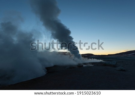 Volcanic activity at sunrise with fumarole and geyser steam in the Andes mountains, Sol de Manana, Uyuni, Bolivia.