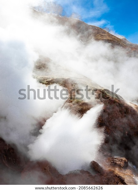 Volcanic activity and thermal field with geyser in the\
Valley of Geysers on the Kamchatka Peninsula. Eruption of  geyser\
in Kamchatka. Geyser close-up. Active fountain of the geyser is\
working. 
