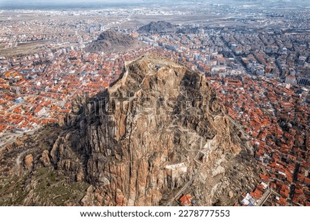 It is a volcanic castle in the city center of Afyonkarahisar, located on a naturally elevated rock mass of 226 meters above the ground, aerial view with drone.