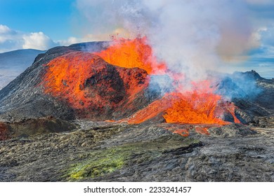 Volcanic eruption in Iceland. Volcano on Reykjanes Peninsula. strong lava flow from a volcanic crater. hot magma flows from crater. reddish and green discoloration from cold magma - Shutterstock ID 2233241457