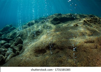 Volcanic Gas Bubbles Through Porous Rock Near The Island Of Flores In Indonesia. This Area Is Part Of The Ring Of Fire, An Active Geologic Region Where Volcanoes Are Prevalent.