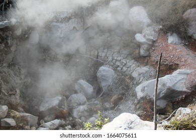 Volcanic grey hot mud bubbling