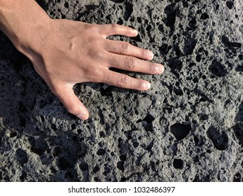 Volcanic ground, touchable.