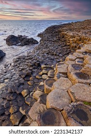 Volcanic hexagonal basalt columns of Giant`s Causeway at sunset in Northern Ireland