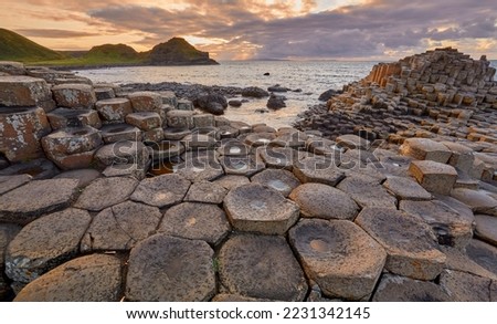 Volcanic hexagonal basalt columns of Giant`s Causeway at sunset in Northern Ireland