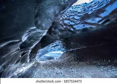 

A Volcanic Ice Cave In Iceland Takes On The Color Of The Black Volcanic Dirt Surrounding The Glacier From Which The Cavern Was Formed.

