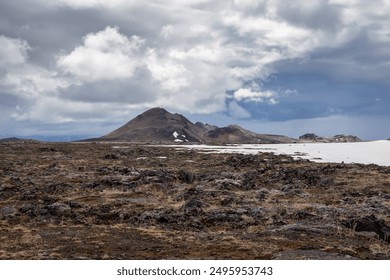 Volcanic landscape of Leirhnjukur, volcano, Myvatn Geothermal Area in Iceland, with hills and lava fields covered with moss and snow. - Powered by Shutterstock