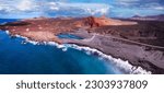 Volcanic Lanzarote island scenery. aerial  panoramic drone view  of Los Hervideros caves and cliffs and Red mountain . popular tourist destination Canary islands
