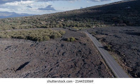 Volcanic mountains aerial drone  landscape with asphalt road in the warm sunny winter windy day with no people around road