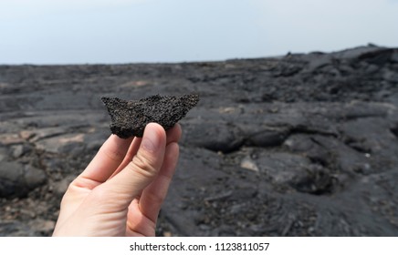 volcanic rock on hands in Lava Tubes, Big Island of Hawaii