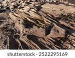 Volcanic stones in Tyningham, UK, showcasing unique textures and colors. These natural formations reflect the geological history of the region, offering a glimpse into the earth