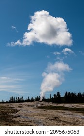 A Volcano Eruption In Yellowstone National Park With Blue Sky On The Background