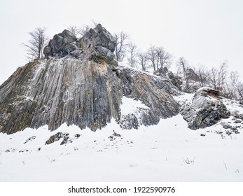 Volcano rock formation Zlaty vrch built pentagonal and hexagonal basalt columns. Looks like giant organ pipes. Covered by snow and ice in winter time - Shutterstock ID 1922590976