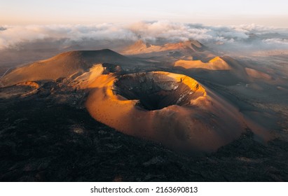 Volcanoes at sunset in Timanfaya National Park in Lanzarote. Popular touristic attraction in Lanzarote island, Canary Islands, Spain - Powered by Shutterstock