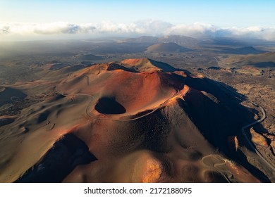 Volcanoes at sunset in Timanfaya National Park in Lanzarote. Popular touristic attraction in Lanzarote island, Canary Islands, Spain