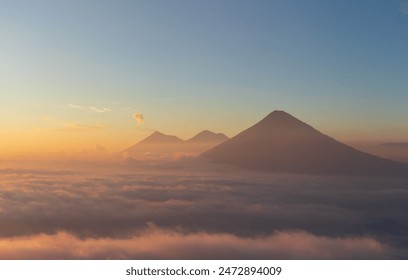 Volcanos agua acatenango and fuego in guatemala with colorful sunset above clouds - Powered by Shutterstock