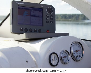 Volga river, Tver region, Russia - 08 21 2020: Fishing motor boat dashboard appliances control gauge on 6000 rpm, middle trim meter, full fuel tank and 8 m depth meter on Raymarine A70 chartplotter 