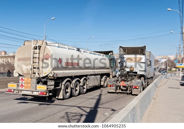 VOLGOGRAD - APRIL 8: A truck with a tank for\
transportation of petroleum products rises on the bridge. April 8,\
2018 in Volgograd,\
Russia.