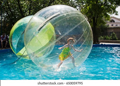 Volgograd, Russia - May 29, 2010: Little Girl Stands In A Balloon Floating On Water In City Park In Volgograd