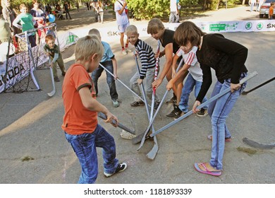Volgograd, Russia - September 02, 2012: Children playing street hockey on a city holiday in Volgograd