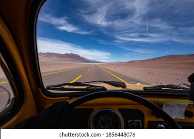 Volkswagen Beetle driver's view across a desert landscape