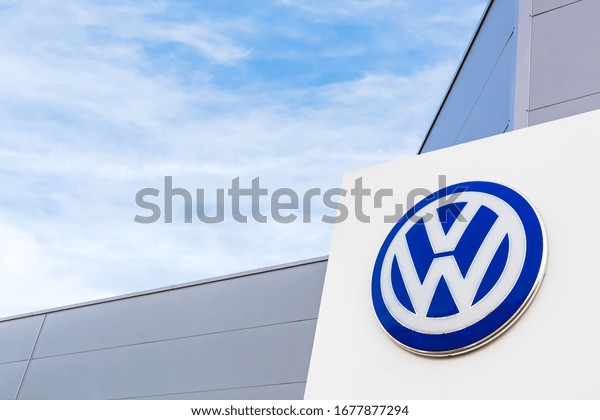 Volkswagen brand logo on bright blue sky background\
located on its dealer office building in Lyon, France - February\
23, 2020