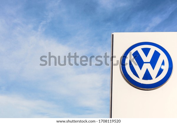 Volkswagen brand logo on bright blue sky background\
located on its dealer office building in Lyon, France - February\
23, 2020